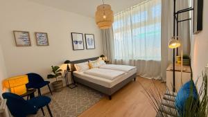 a small bedroom with a bed and a window at BeckHomes Munich - Stylish Central Apartments in Munich