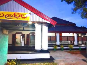 a building with a sign on the side of it at Walawwa Resort Kurunegala in Kurunegala
