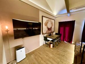 a living room with a table and a red curtain at Gouhou Garden Hotel Asakusa in Tokyo