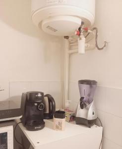 a kitchen counter with a blender on top of it at Charmant studio in Paris