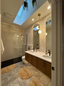 a bathroom with a sink and a shower and a toilet at European inspired cottage in Spring Lake +32 photos