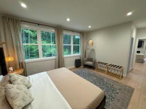 a bedroom with a large bed and a window at European inspired cottage in Spring Lake