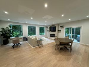 a living room with a table and a couch at European inspired cottage in Spring Lake