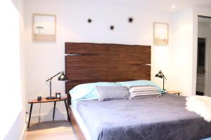 ロサンゼルスにあるHeart Of West hollywood 2 Bedroom 2 Bathの木製のヘッドボードが付いた大きなベッドのある寝室