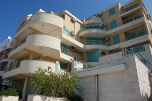an apartment building with balconies on the side of it at Villa Nova Premium Apartment No 5 in Prijevorac
