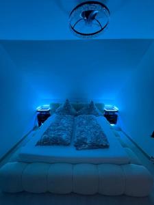 a bedroom with a bed with a blue light at Ays-SPA, Whirlpool & Sauna in Iserlohn