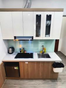 a kitchen with white cabinets and a sink at TV-Netflix STU 302 Near Uncle Ho's Mausoleum in Hanoi
