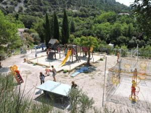 a group of children playing in a playground at Mobil-home cosy 2 chambres en Provence - API-1-52-437 in Venterol +17 photos