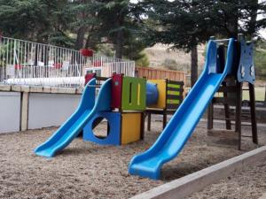 a playground with a slide in a park at Chalet confortable avec terrasse à Sournia - API-1-52-491 in Sournia