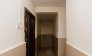 an empty hallway with an open door in a building at Hotel O Diplomat in Sopāra +39 photos