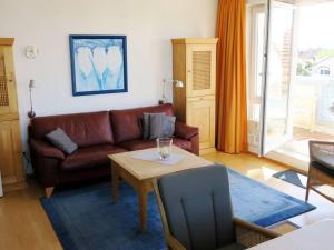 a living room with a couch and a table at Kaiserhof 302 in Wangerooge