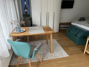 a room with a table and a chair and a bed at Lighthousestudio & Spa- Exclusive Entspannt Besonders in Wangerooge