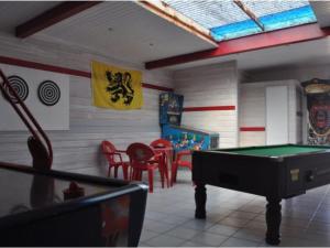 a room with a pool table and some chairs at Mobil-home 33m² avec terrasse au Boulou - API-1-52-398 in Le Boulou