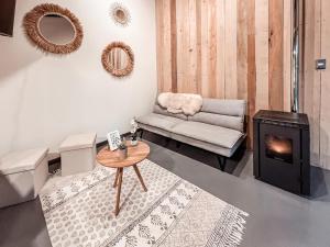 a living room with a couch and a fireplace at suite campestre con terraza in Puerto Varas