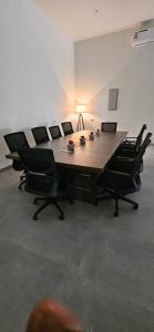 a conference room with a long table and chairs at Sugardunes Beach Resort in Ghadw +22 photos