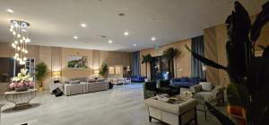 a lobby with couches and chairs in a building at Sugardunes Beach Resort in Ghadw