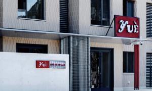 a building with a sign on the side of it at YUE HOTEL in Dapuhe