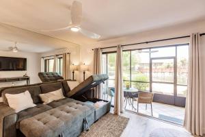 a living room with a couch and a sliding glass door at Park Shore Resort-Deluxe Condo 1st FloorBLDGE 134 in Naples