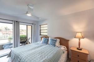 a bedroom with a bed with a lamp and a window at Park Shore Resort-Deluxe Condo 1st FloorBLDGE 134 in Naples +34 photos