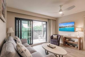 a living room with a couch and a table at Park Shore Resort Deluxe Condo Top FloorBLDG F 339 in Naples