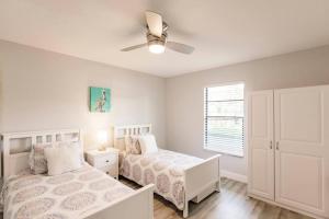 a bedroom with two beds and a ceiling fan at Park Shore Resort-1st Floor Condo-Park 101 in Naples +43 photos