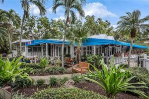 a house with palm trees in front of it at Park Shore Resort-1st Floor Condo-Park 101 in Naples