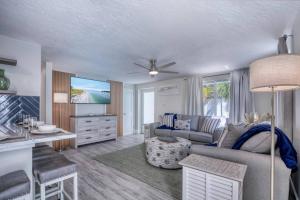 a living room with a couch and a table at Restorative Escape-Moonlit Waters-Steps to beach. in Holmes Beach