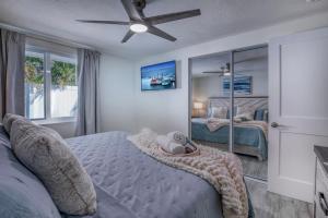 a bedroom with two beds and a ceiling fan at Restorative Escape-Moonlit Waters-Steps to beach. in Holmes Beach +45 photos