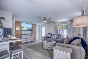 a living room with a couch and a table at Tranquility Meets Style-Walk to beach-prvt pool. in Holmes Beach