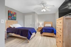 a bedroom with two beds and a ceiling fan at 4BR 6BD Pool HotTub Atlantic Ave in Delray Beach +62 photos