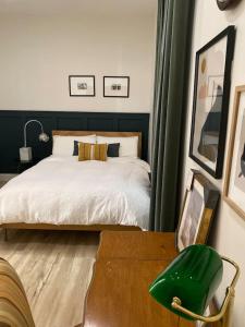 a bedroom with a bed and a green chair at Garden Oasis 3BR 15 min FIFA World Cup MetLife Std in Harrison