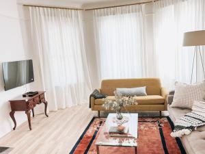 a living room with a couch and a table at Garden Oasis 3BR 15 min FIFA World Cup MetLife Std in Harrison