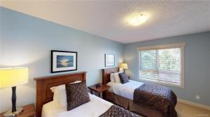 a bedroom with two beds and a window at Sooke Harbour Penthouse in Sooke