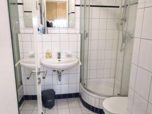a bathroom with a sink and a shower and a toilet at Kaiserhof 010 in Wangerooge