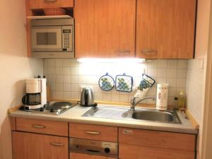 a kitchen with a sink and a microwave at Kaiserhof 010 in Wangerooge