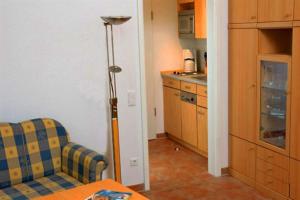 a kitchen with a table and two chairs in a room at Kaiserhof 010 in Wangerooge