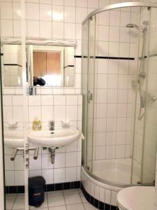 a bathroom with a sink and a shower and a toilet at Kaiserhof 010 in Wangerooge
