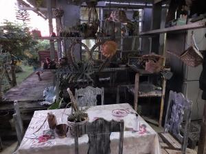 a dining room with a table and chairs and a table at Rootscamp in Surinam