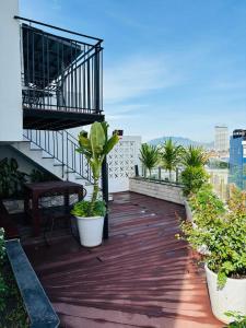 a balcony with potted plants on a building at Modern Garden Apt by Dragon bridge in Da Nang