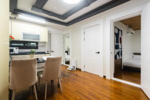a kitchen and dining room with a table and chairs at Thema Stay Hotel in Pyeongtaek
