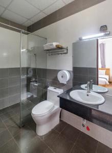 a bathroom with a toilet and a sink and a shower at Lan Viên Villa in Da Lat