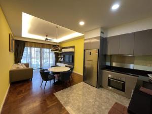 a kitchen with a table and a dining room at CHARMING & COZY PREMIER SUITES @ VISTA RESIDENCE in Genting Highlands