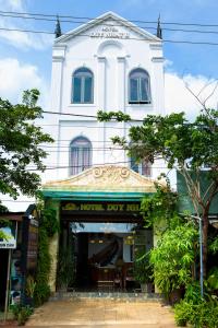 a white building with a store in front of it at HOTEL DUY NHẤT 2 in Phú Nhơn