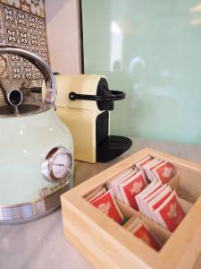 a tea kettle next to a box of matches at Domus Fidias in Rhodes Town +33 photos