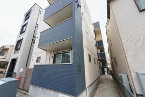 ein Gebäude mit blauen Tafeln an der Seite in der Unterkunft 6 min to Nagoya Brand-new building Sleeps 5 in Nagoya