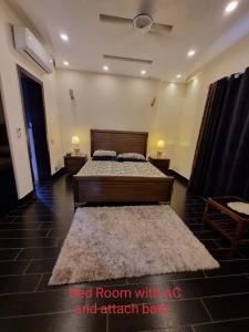 a bedroom with a bed room with ac and artificial bark at DHA Luxe Stay in Lahore