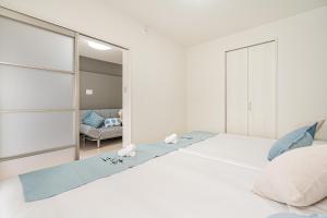 Ένα ή περισσότερα κρεβάτια σε δωμάτιο στο 桜の川70-39 駒込駅2分 2-5人丨2 minutes from Komagome Station 2-5 people