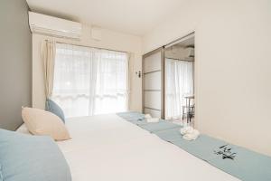 Ένα ή περισσότερα κρεβάτια σε δωμάτιο στο 桜の川70-39 駒込駅2分 2-5人丨2 minutes from Komagome Station 2-5 people +37 φωτογραφίες