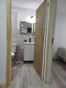 a bathroom with a sink and a toilet and a mirror at Dorado Stey 2 in Río Grande +10 photos