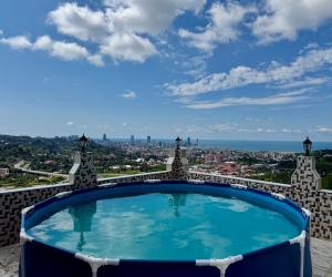a swimming pool on top of a building with a city at GT House Batumi in Batumi
